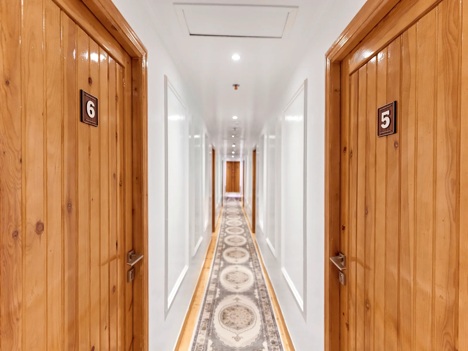 Wood-panelled cabin corridor aboard Fatima Dahabeya