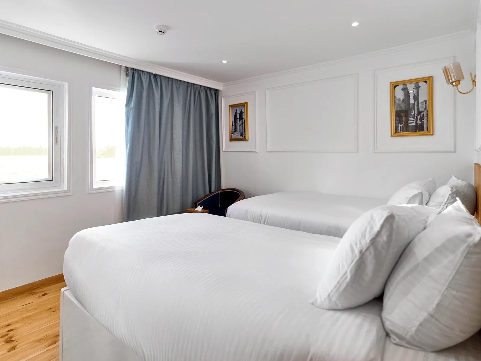 Fatima Dahabeya cabin with white bedding and Nile-facing window