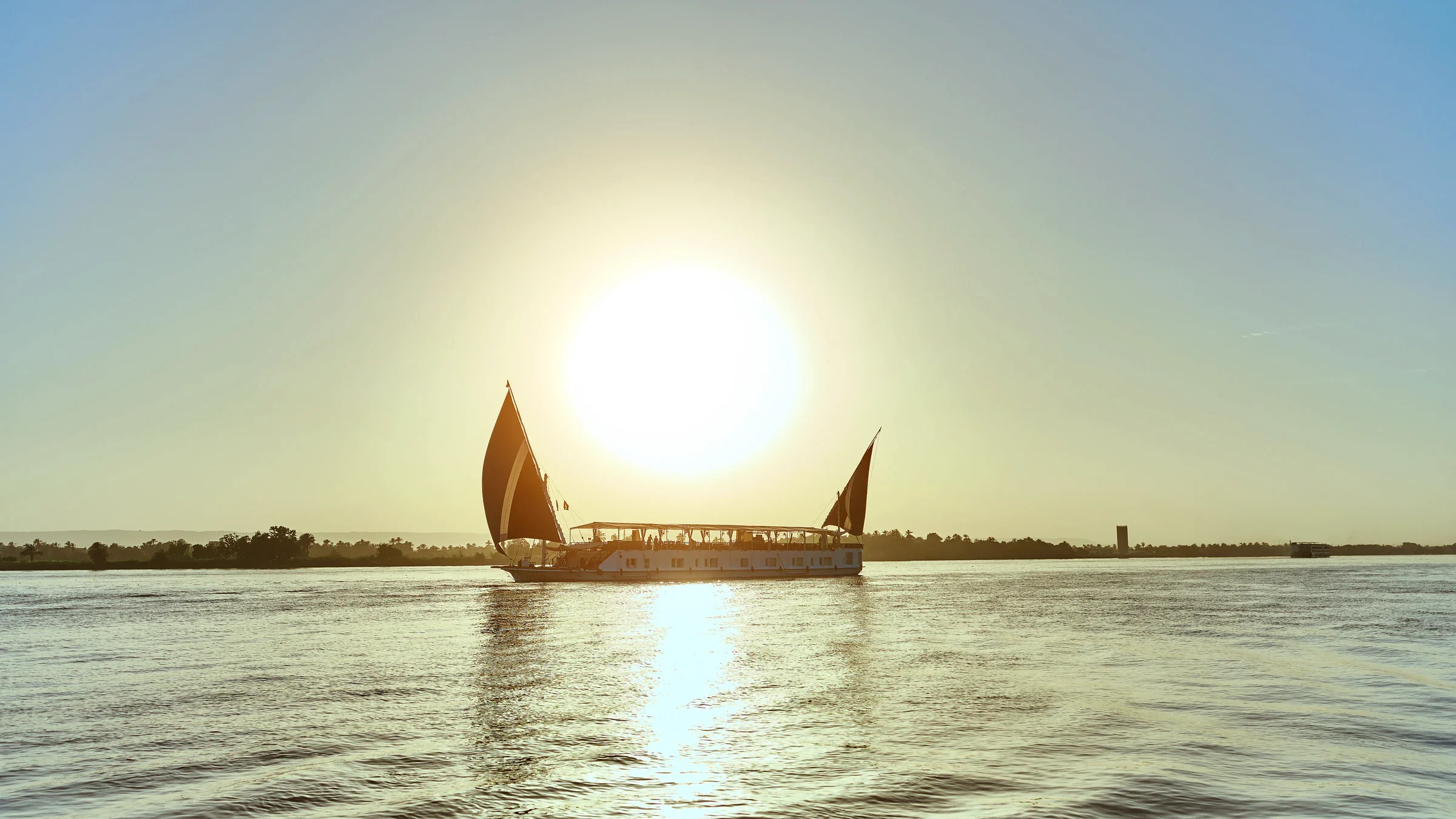 Fatima Dahabeya silhouetted against sunset on the Nile