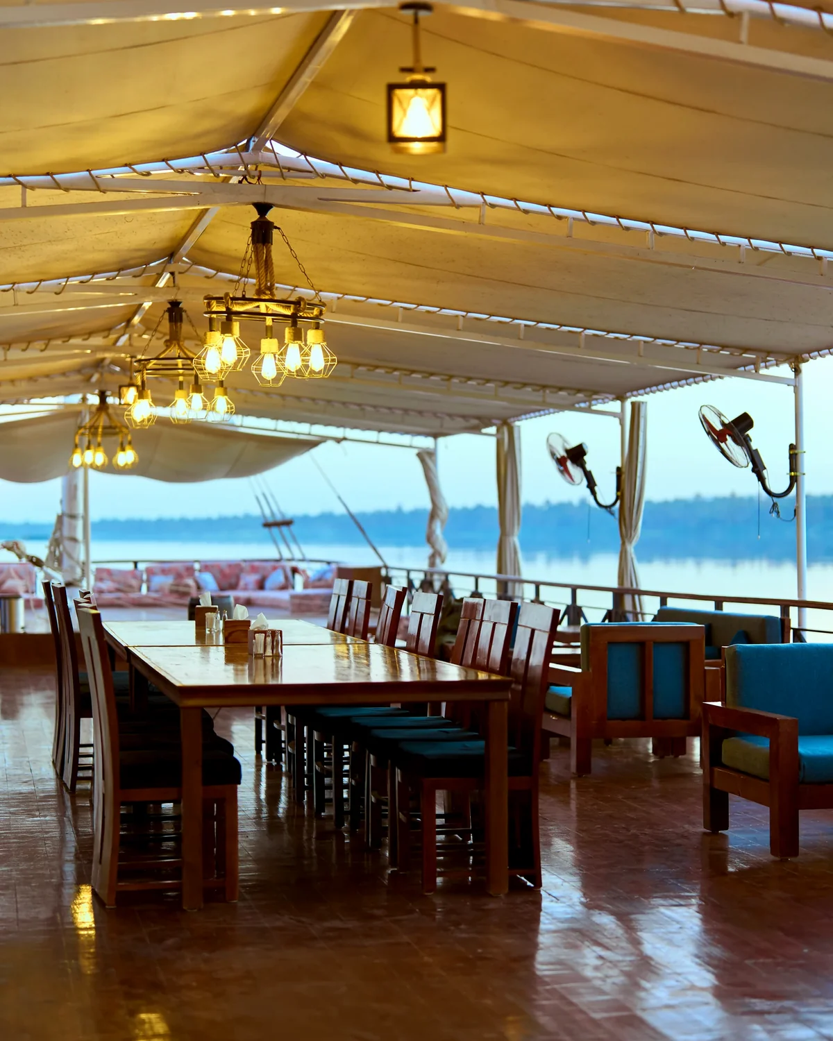Open-air dining tables on the upper deck of Fatima Dahabeya