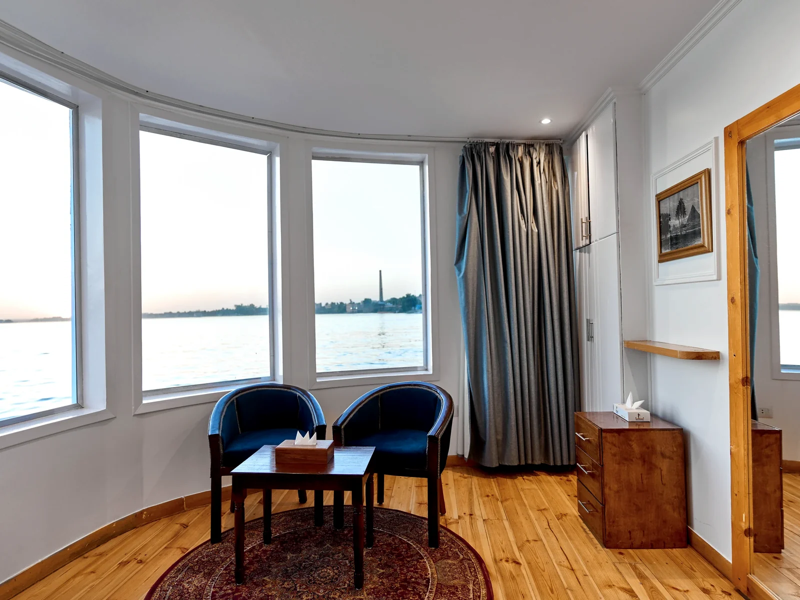 Wide Nile-facing windows and seating in a Fatima Dahabeya panoramic suite