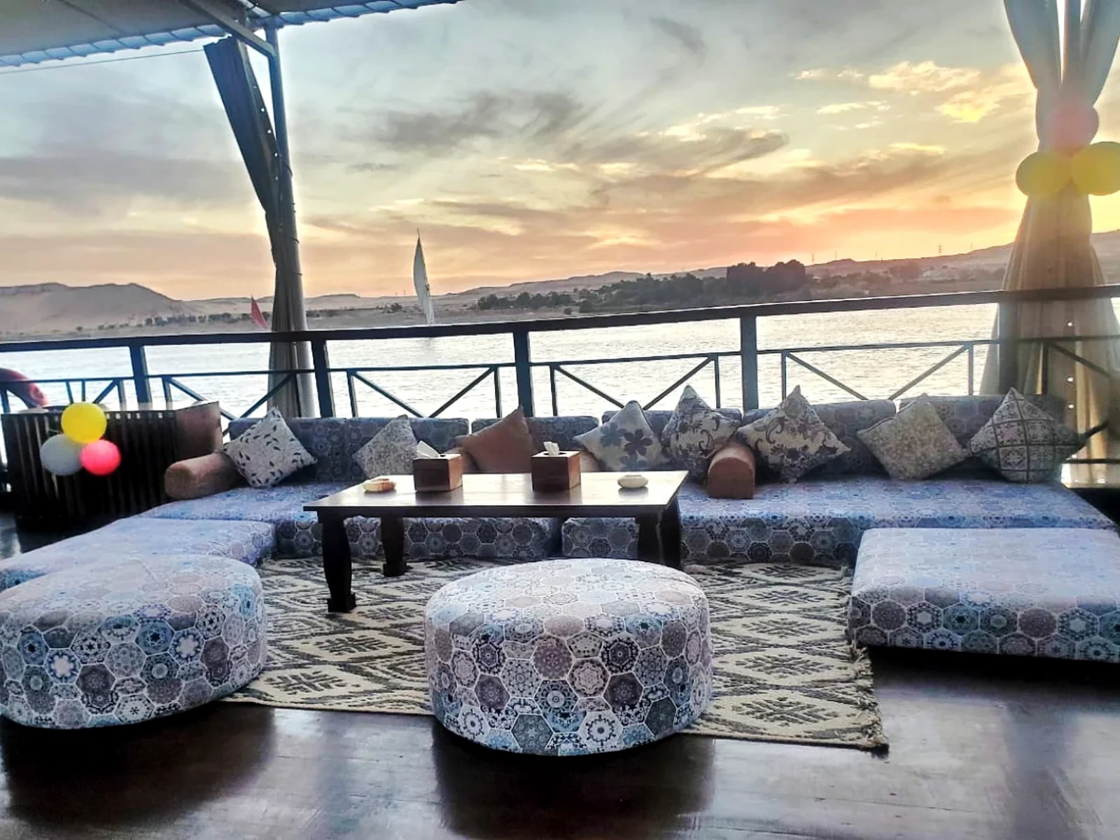 Private upper-deck lounge aboard Fatima Dahabeya at sunset